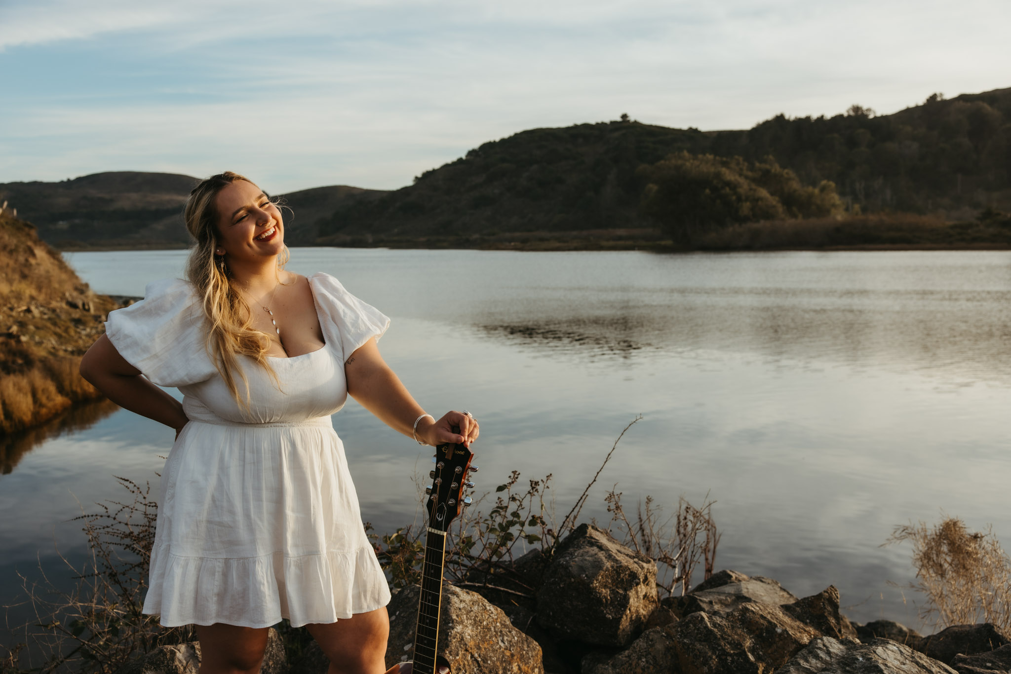 Sunny Mitchell with guitar at sunset